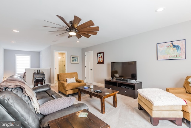 carpeted living room with ceiling fan