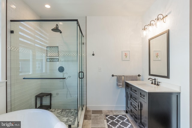 bathroom with walk in shower and vanity