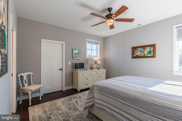 bedroom with ceiling fan and dark wood-type flooring