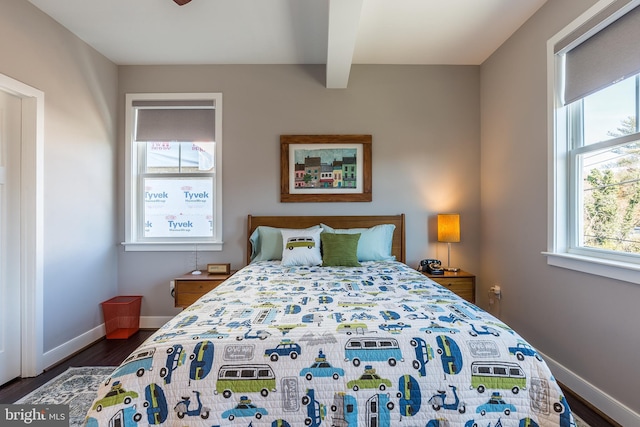 bedroom featuring dark hardwood / wood-style flooring and beamed ceiling