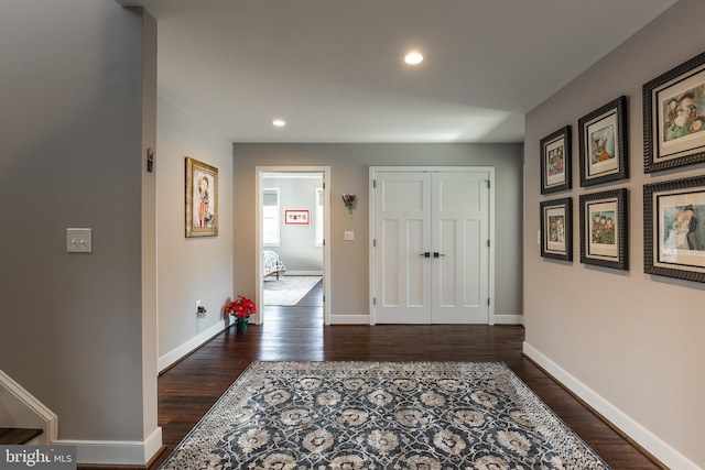 corridor with dark hardwood / wood-style flooring