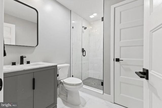 bathroom featuring vanity, toilet, and a shower with door