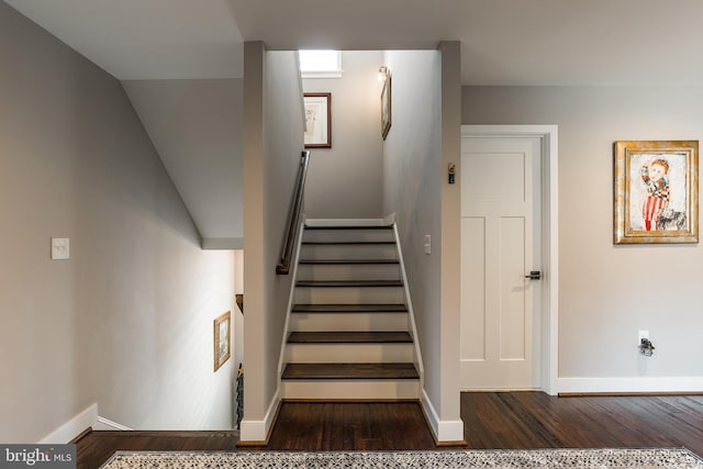 staircase with lofted ceiling and hardwood / wood-style flooring