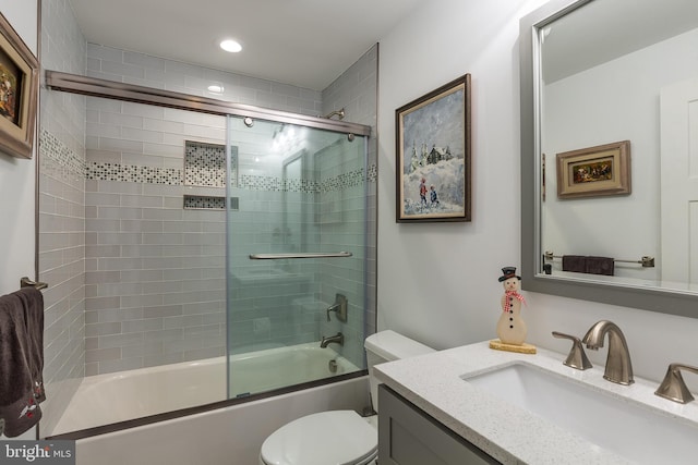 full bathroom with toilet, combined bath / shower with glass door, and vanity