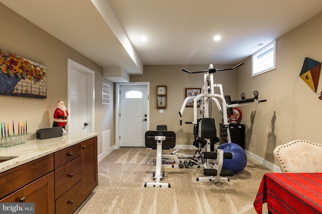 workout room featuring light colored carpet