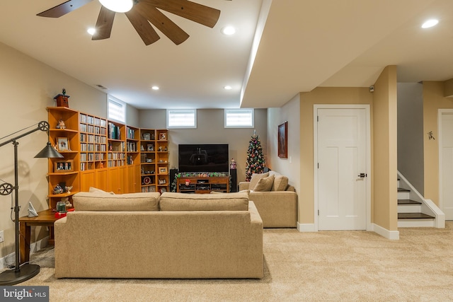 carpeted living room featuring ceiling fan