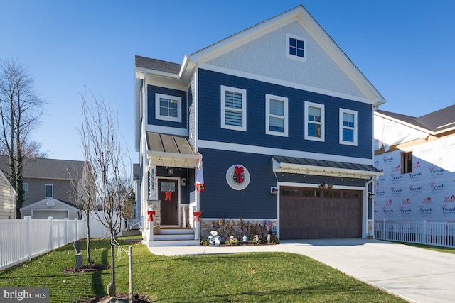 view of front of house featuring a front yard and a garage