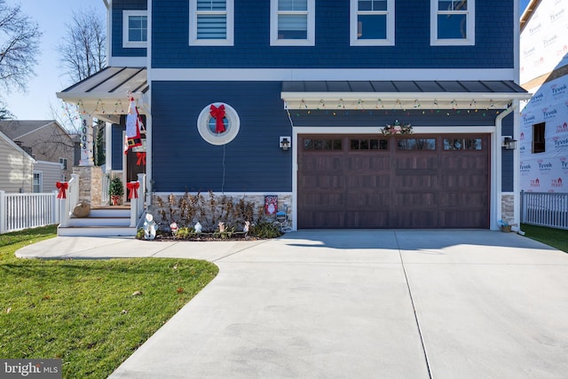 view of front of house featuring a garage and a front lawn