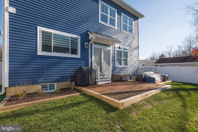 rear view of house with a yard