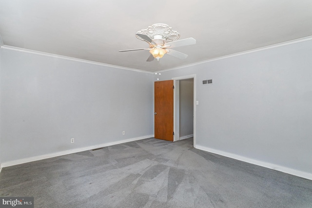 empty room with visible vents, baseboards, ceiling fan, ornamental molding, and carpet flooring