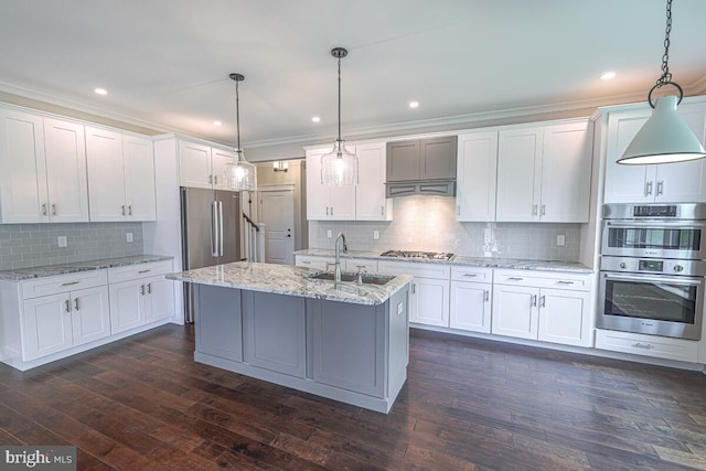 kitchen featuring white cabinets, dark wood finished floors, stainless steel appliances, and a sink