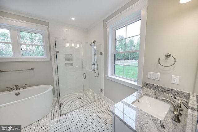 full bath featuring a soaking tub, ornamental molding, a shower stall, vanity, and baseboards