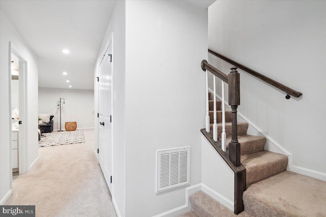 stairs with visible vents, baseboards, recessed lighting, and carpet floors