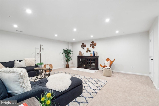 carpeted living area with recessed lighting, visible vents, and baseboards