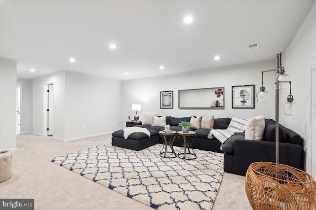 living room featuring light colored carpet, baseboards, visible vents, and recessed lighting