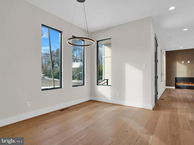 unfurnished dining area featuring light hardwood / wood-style flooring