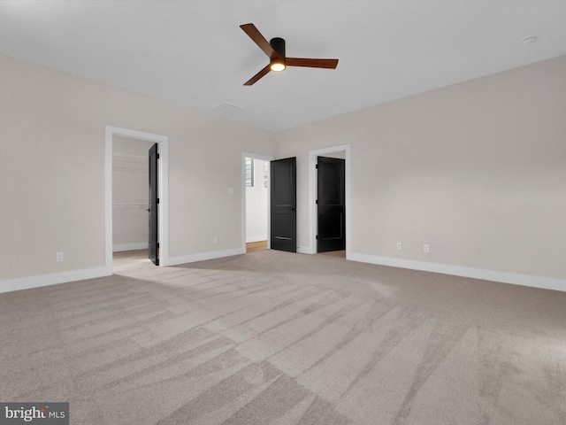 unfurnished room with light colored carpet and ceiling fan