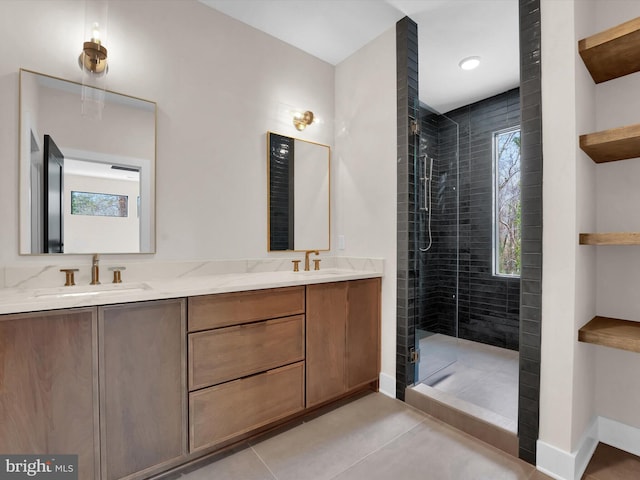 bathroom with vanity, tiled shower, and tile patterned floors