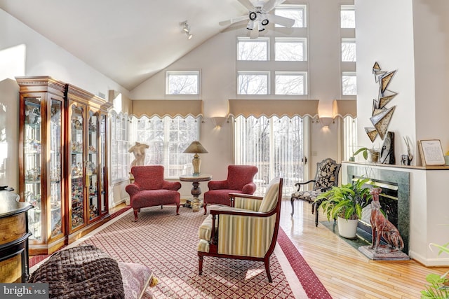 sunroom / solarium with a premium fireplace and ceiling fan