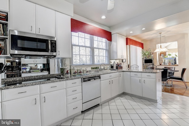 kitchen featuring dishwasher, white cabinets, sink, ceiling fan, and kitchen peninsula