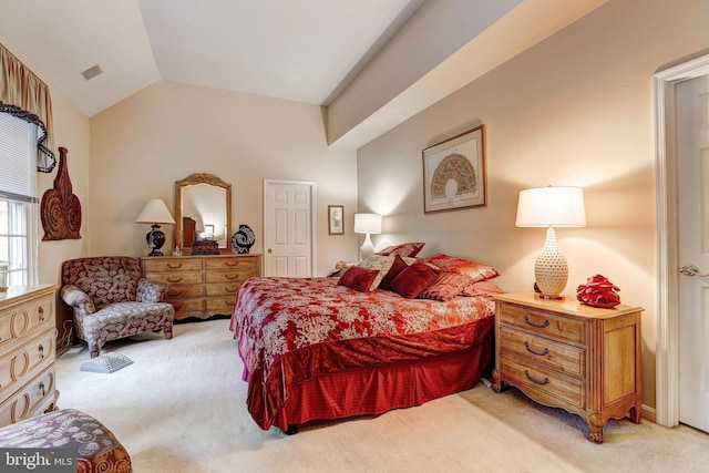 carpeted bedroom with vaulted ceiling