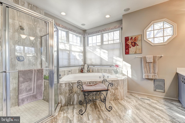 bathroom featuring plus walk in shower and vanity