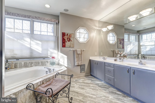 bathroom with tiled bath and vanity