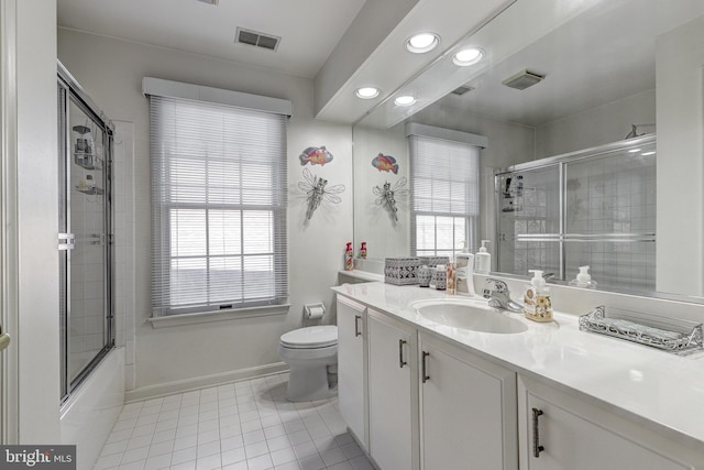 full bathroom with toilet, vanity, tile patterned floors, and enclosed tub / shower combo