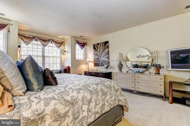 bedroom featuring light carpet