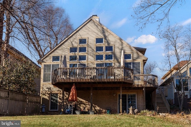 back of property with a yard and a wooden deck