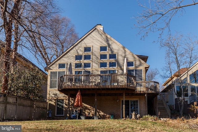 rear view of house featuring a deck