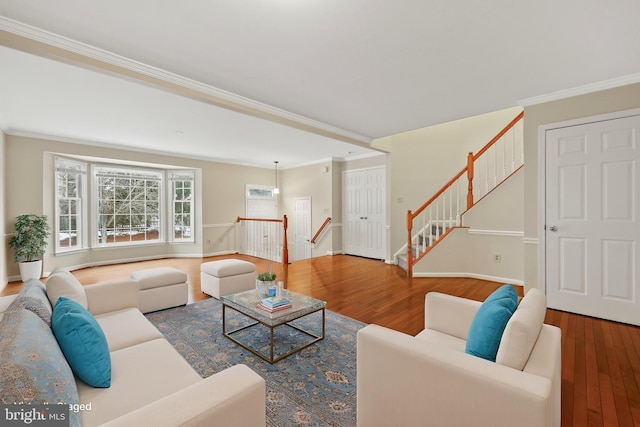 living room with hardwood / wood-style flooring and crown molding