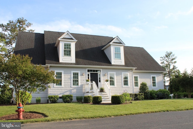 cape cod-style house with a front yard