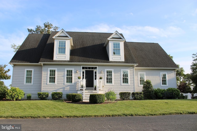 new england style home with a front yard