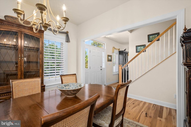 dining space with an inviting chandelier and hardwood / wood-style flooring