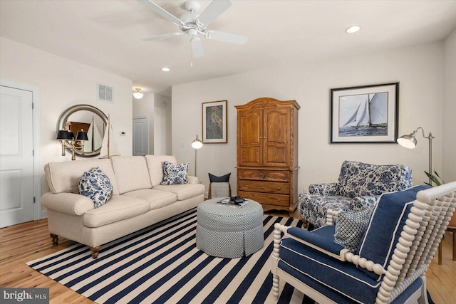 living room featuring light hardwood / wood-style floors and ceiling fan