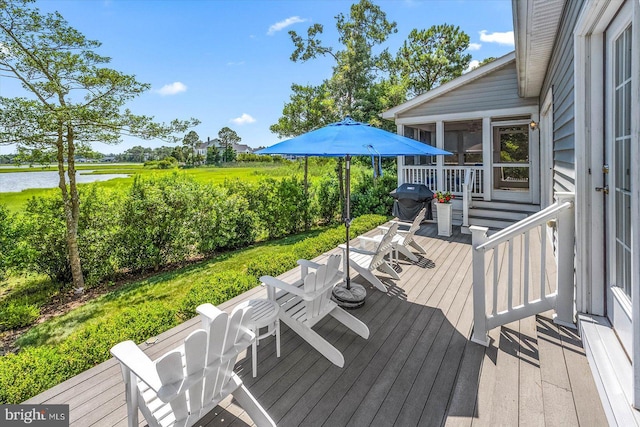 wooden terrace with a sunroom and a water view