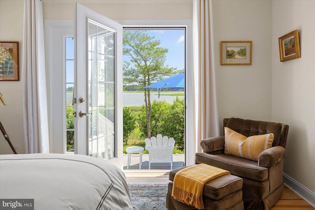 bedroom featuring access to outside and hardwood / wood-style flooring