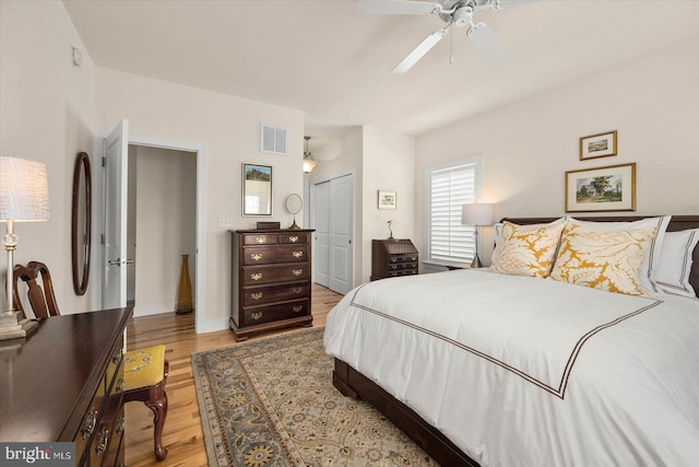 bedroom featuring light wood-type flooring, a closet, and ceiling fan