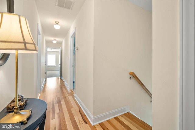 hallway with light hardwood / wood-style flooring