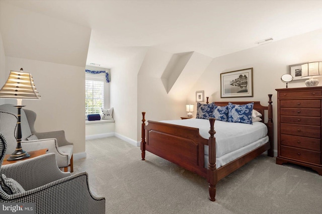 carpeted bedroom with vaulted ceiling