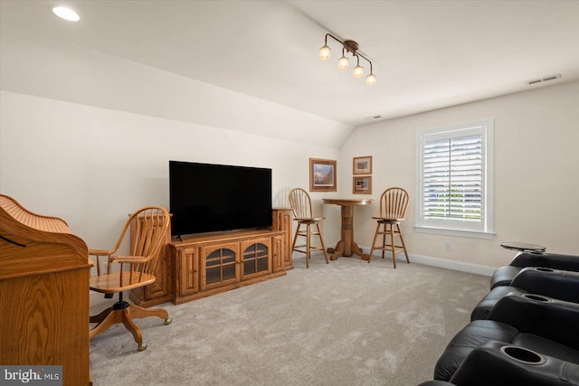 living room featuring light colored carpet and vaulted ceiling