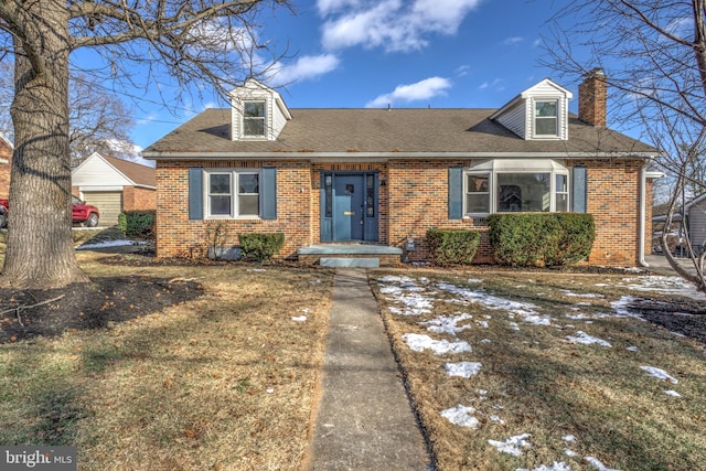 cape cod home with a front lawn