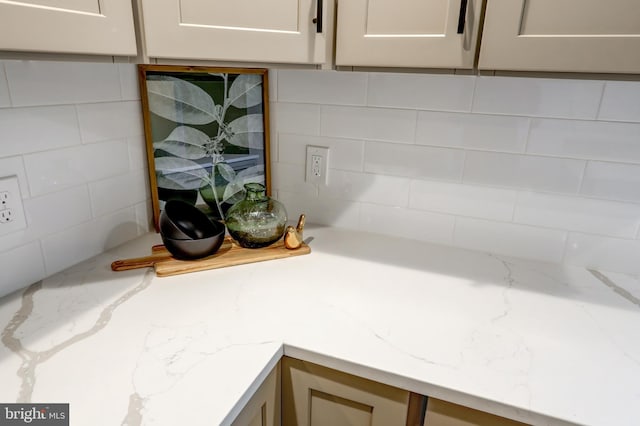 interior details featuring light stone counters and backsplash