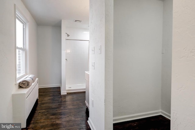 corridor with dark hardwood / wood-style flooring