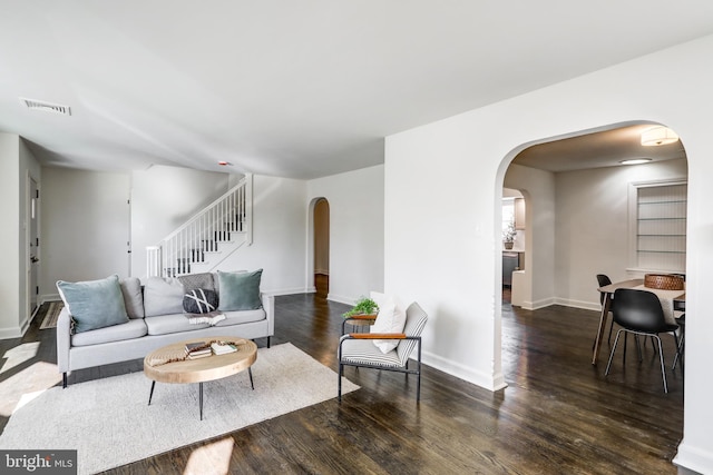 living room featuring dark wood-type flooring