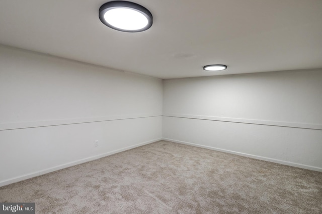 unfurnished room with light colored carpet