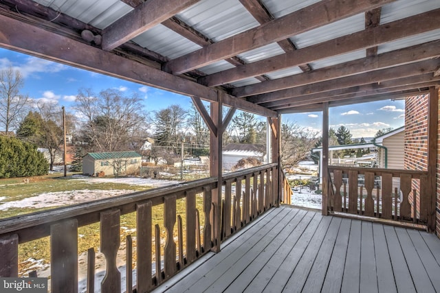 wooden terrace featuring a shed