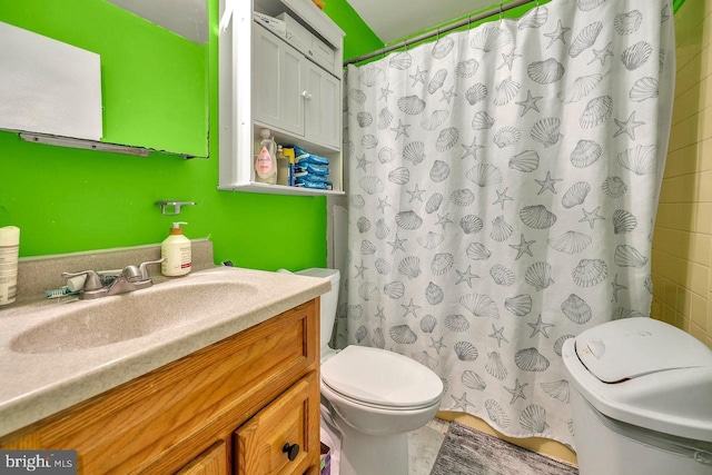 bathroom featuring vanity, toilet, and walk in shower