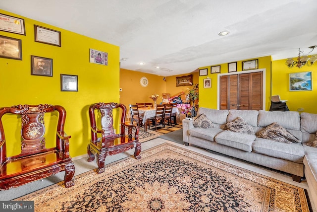 living room with carpet flooring and an inviting chandelier